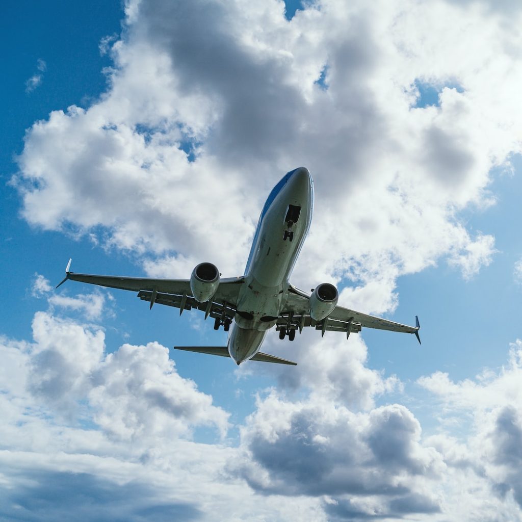 low-angle photography of airliner during flight